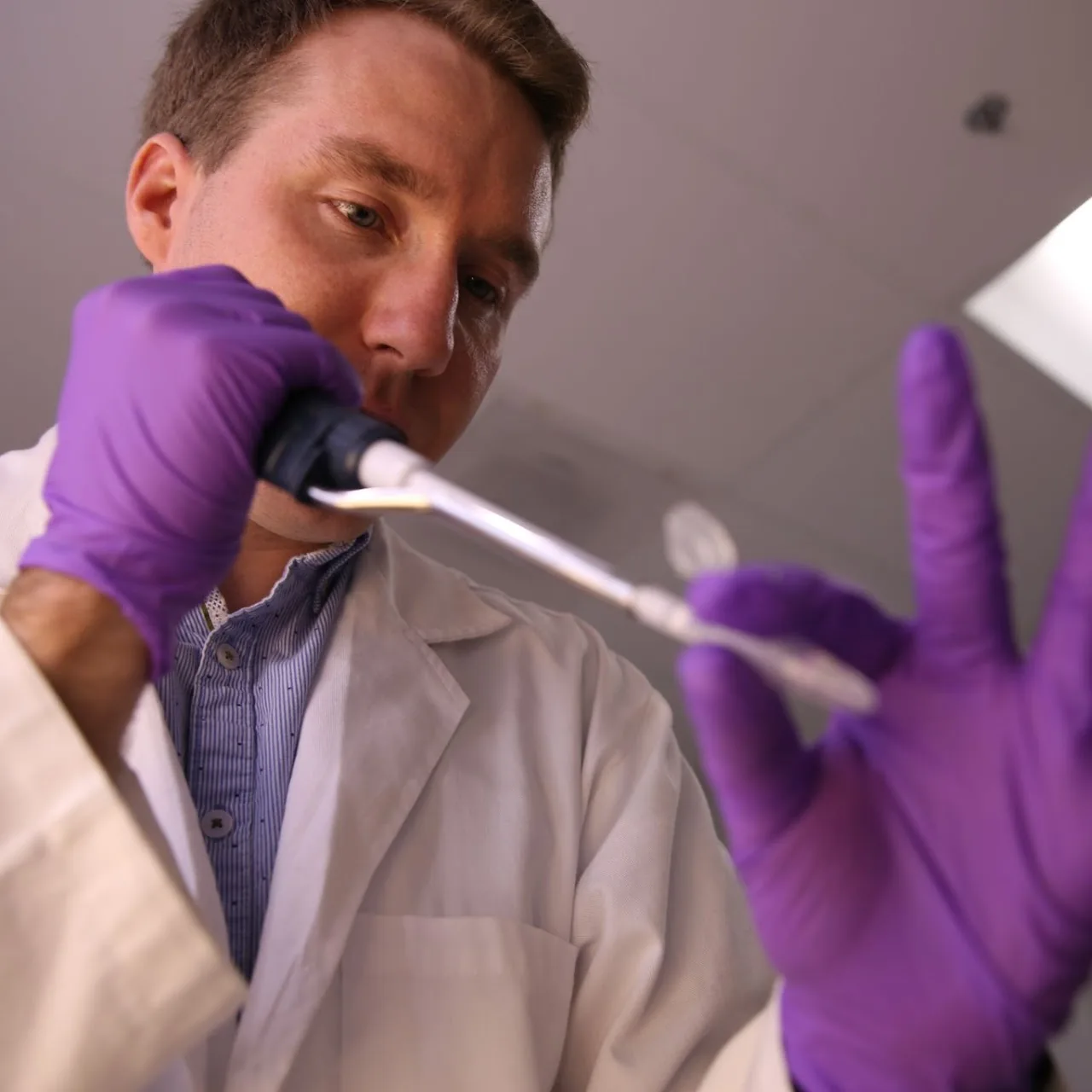 Antonio Lamb pipetting at the bench
