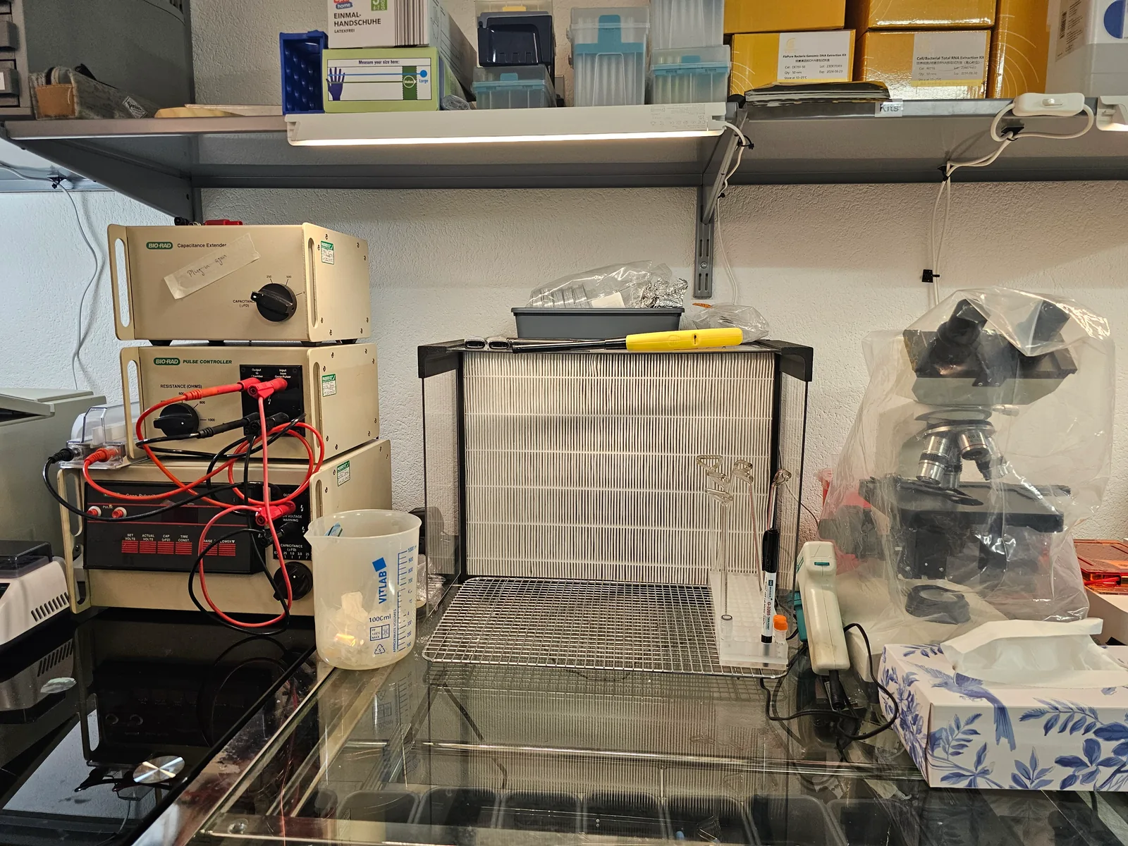 Lambda Biolab bench with gel electrophoresis power supplies, microscope, and glassware