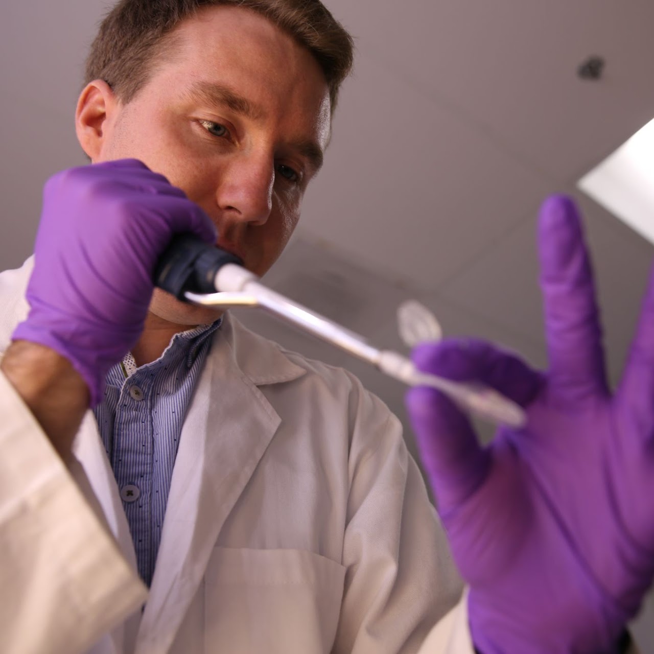 Antonio pipetting at the bench